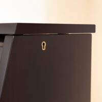 Close-up of ebony Yamaha upright piano lid, highlighting quality craftsmanship and precision finish at Classic Pianos.