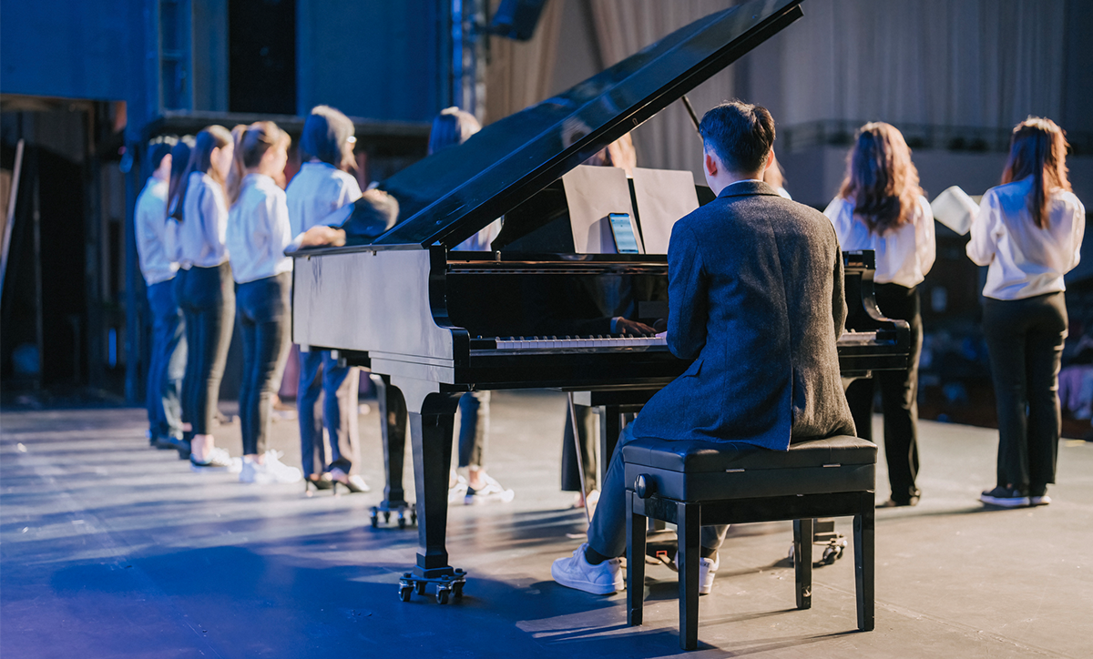 Pianist and Choir chorus performance group singing on stage