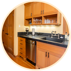 Modern kitchen with wooden cabinets and stainless appliances, showcasing elegant design and functionality.