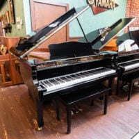 Yamaha grand piano in polished ebony finish at Classic Pianos Portland showroom.