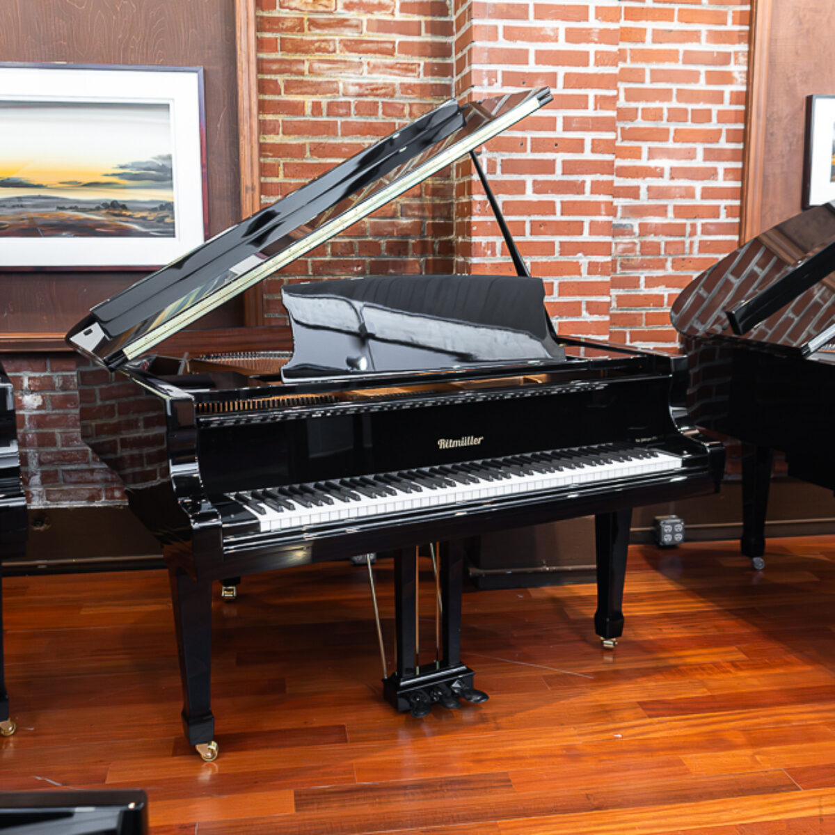 Ritmüller grand piano with polished ebony finish at Classic Pianos Portland showroom, showcasing superior craftsmanship.