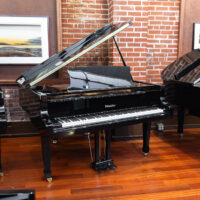 Ritmüller grand piano with polished ebony finish at Classic Pianos Portland showroom, showcasing superior craftsmanship.