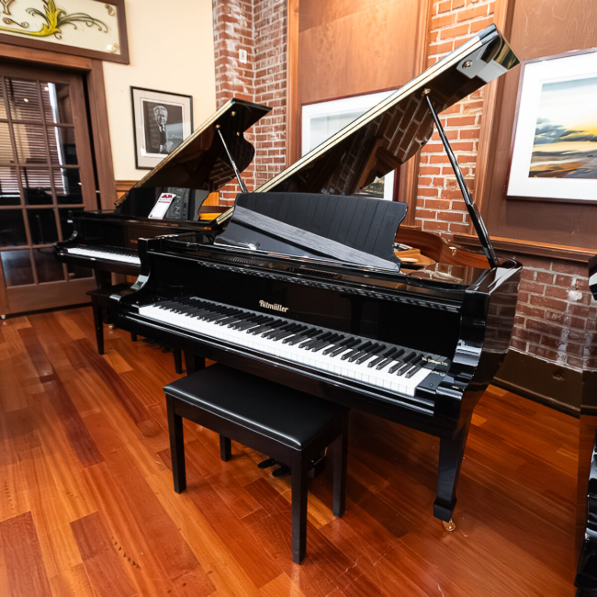 Alt text: Ritmüller grand piano with polished ebony finish at Classic Pianos Portland showroom.