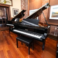 Alt text: Ritmüller grand piano with polished ebony finish at Classic Pianos Portland showroom.