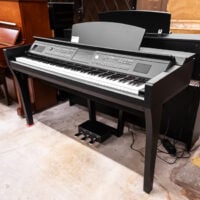 Digital piano featuring advanced sound system and sleek black finish at Classic Pianos in Portland showroom.
