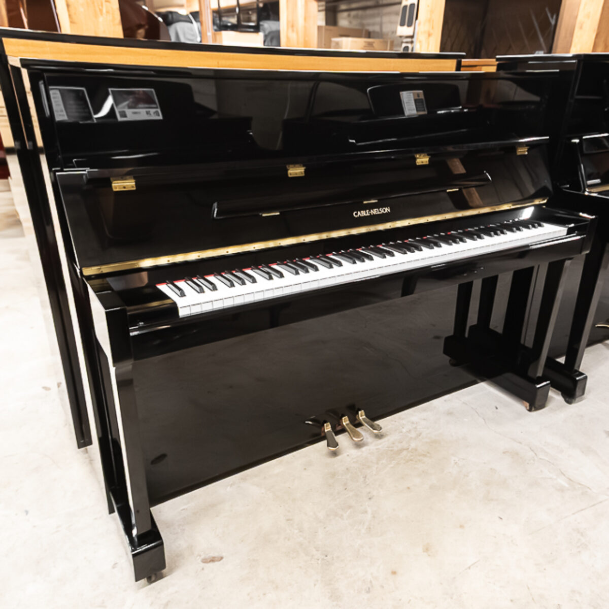 Cline Nelson upright piano, polished ebony finish, available at Classic Pianos Portland showroom.