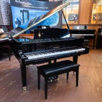 Yamaha AvantGrand grand piano showcasing polished ebony finish, premium keys, and advanced sound technology in a showroom.