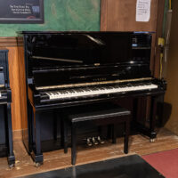 Yamaha G3 upright piano in polished ebony finish, featuring a sleek design and responsive action for ultimate performance.