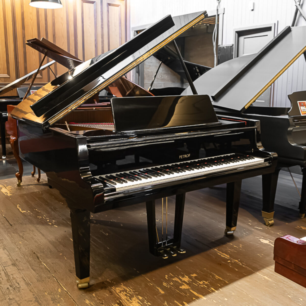 Alt text: Petrof grand piano with a polished ebony finish, showcasing premium craftsmanship and elegant design at Classic Pianos.