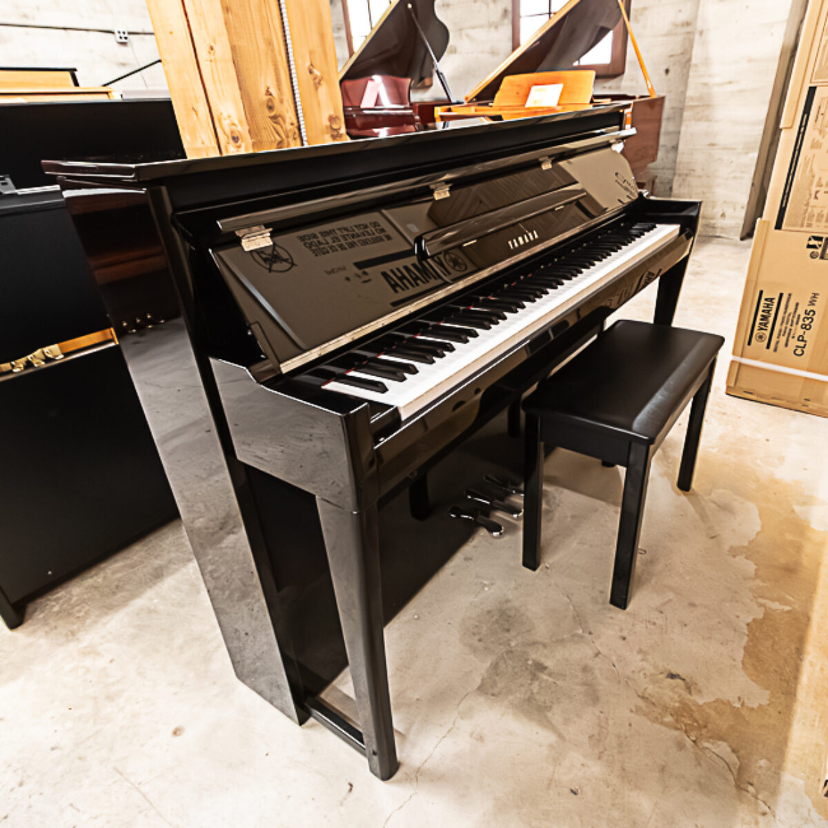 Yamaha U1 upright piano in sleek black finish, featuring weighted keys and matching bench for an elegant touch.