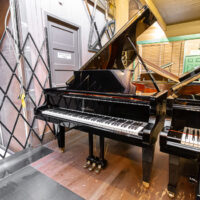 Schimmel grand piano showcasing premium craftsmanship and rich tones, located at Classic Pianos Portland showroom.