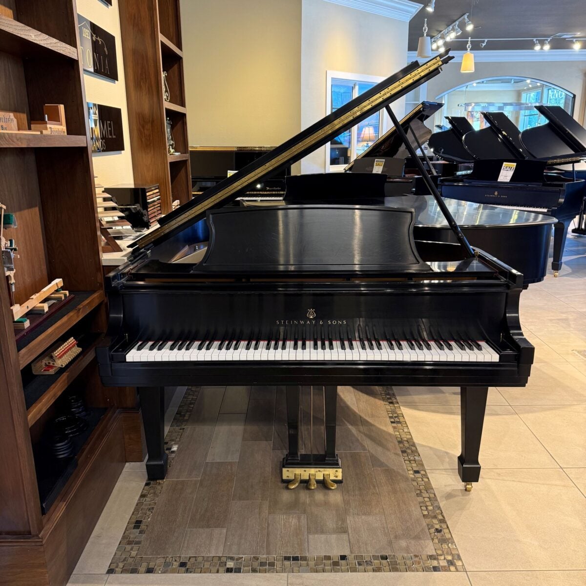 Steinway & Sons grand piano showcasing polished ebony finish and distinctive craftsmanship, perfect for any musician's collection.