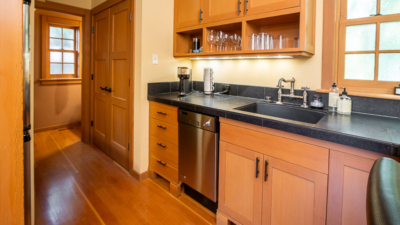 Contemporary kitchen setup with wood cabinetry and stainless steel appliances, showcasing modern interior design elegance.