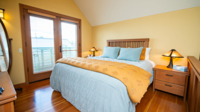 Warm, inviting bedroom with wooden furniture, perfect for relaxing after exploring Classic Pianos' premium selections.