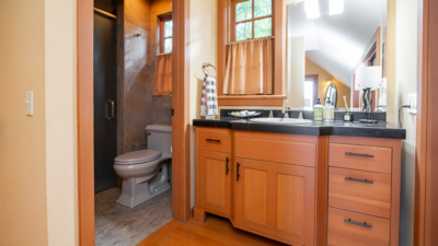 Modern bathroom interior with wooden cabinets, sleek fixtures, and warm lighting. Cozy and inviting space design.